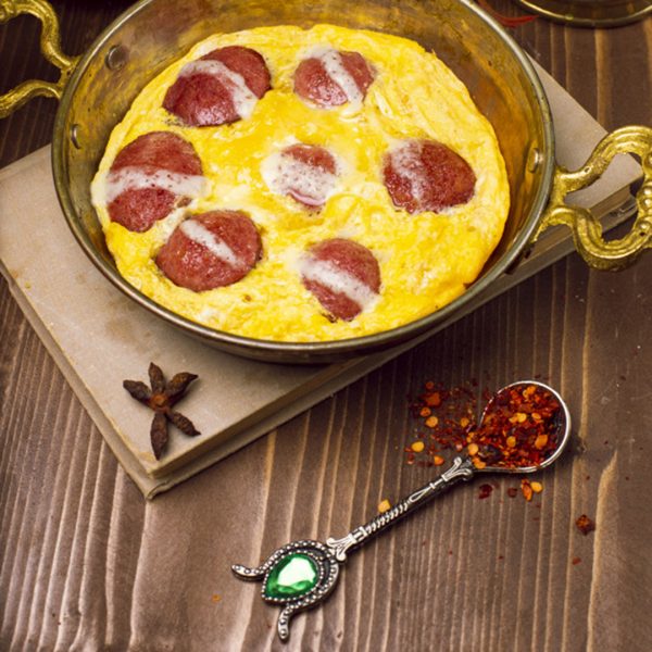 Fried eggs omlette with sucuk in a pan. Traditional turkish breakfast - Image