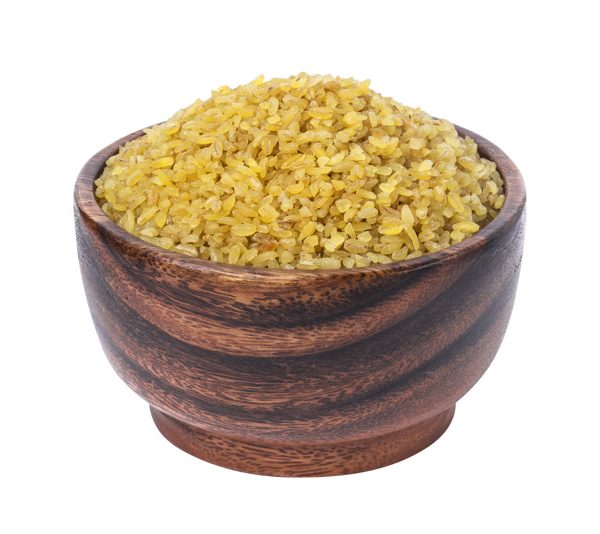 Dry bulgur wheat in wooden bowl isolated on white background. One of the collection
